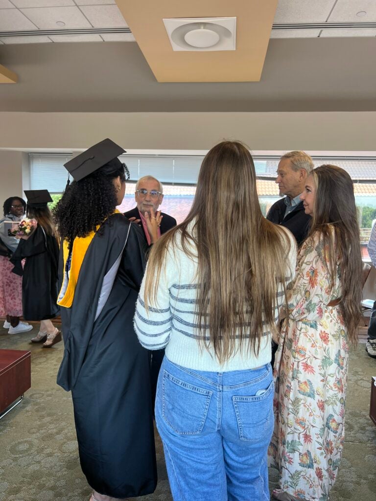 Students, faculty, and friends gather to celebrate at the reception.